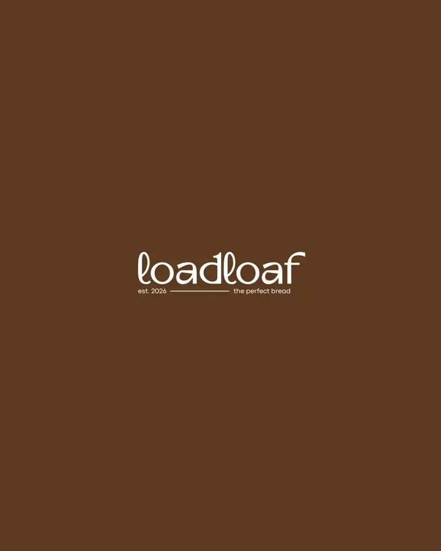 Loadloaf wordmark with the line est. 2026 — the perfect bread, in cream on warm brown