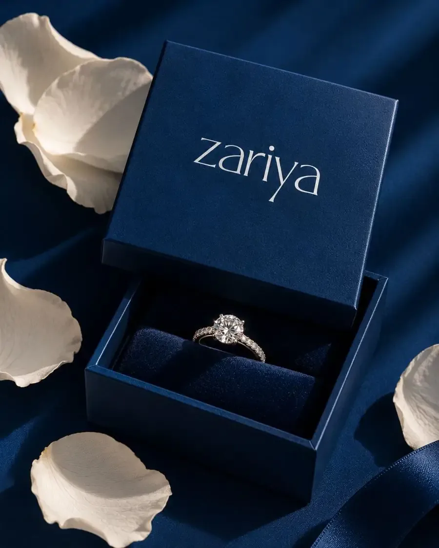 Diamond ring in an open navy Zariya ring box with white petals