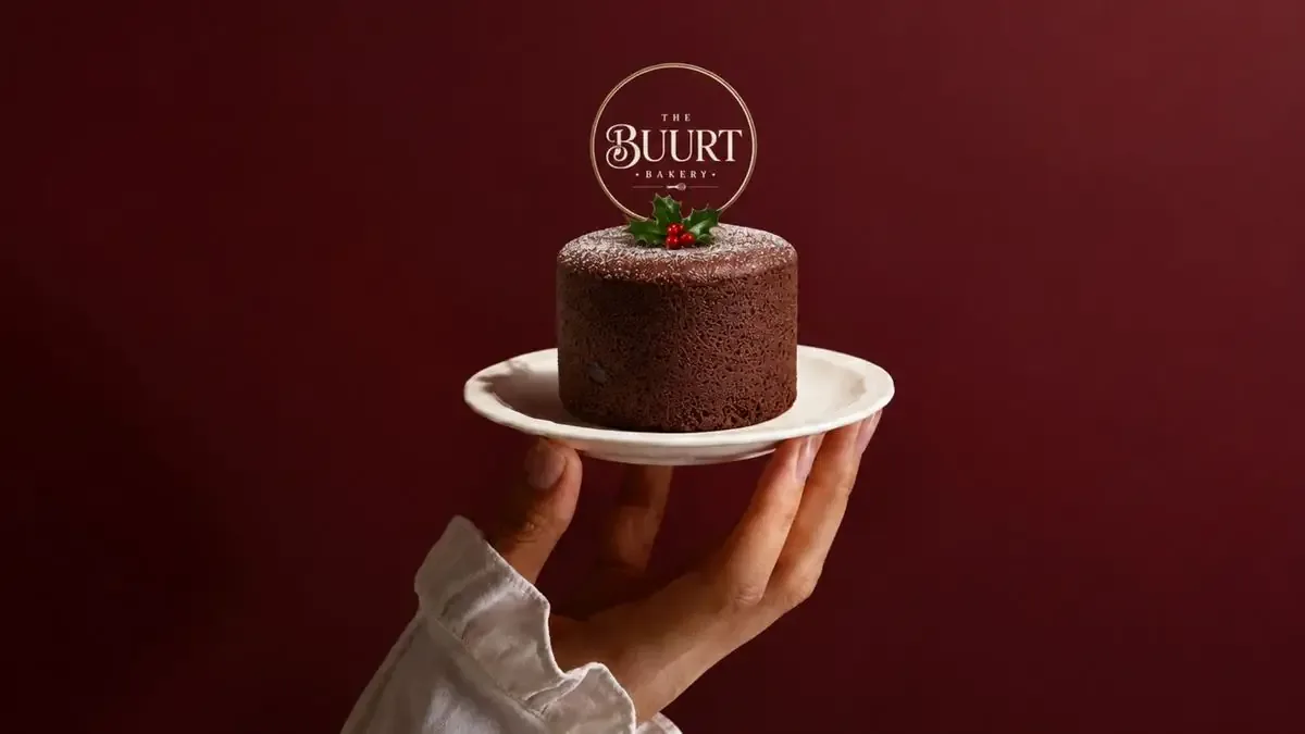 Chocolate cake with a gold The Buurt Bakery cake topper