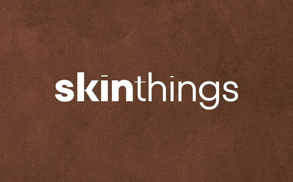 Skinthings wordmark in white on textured chocolate